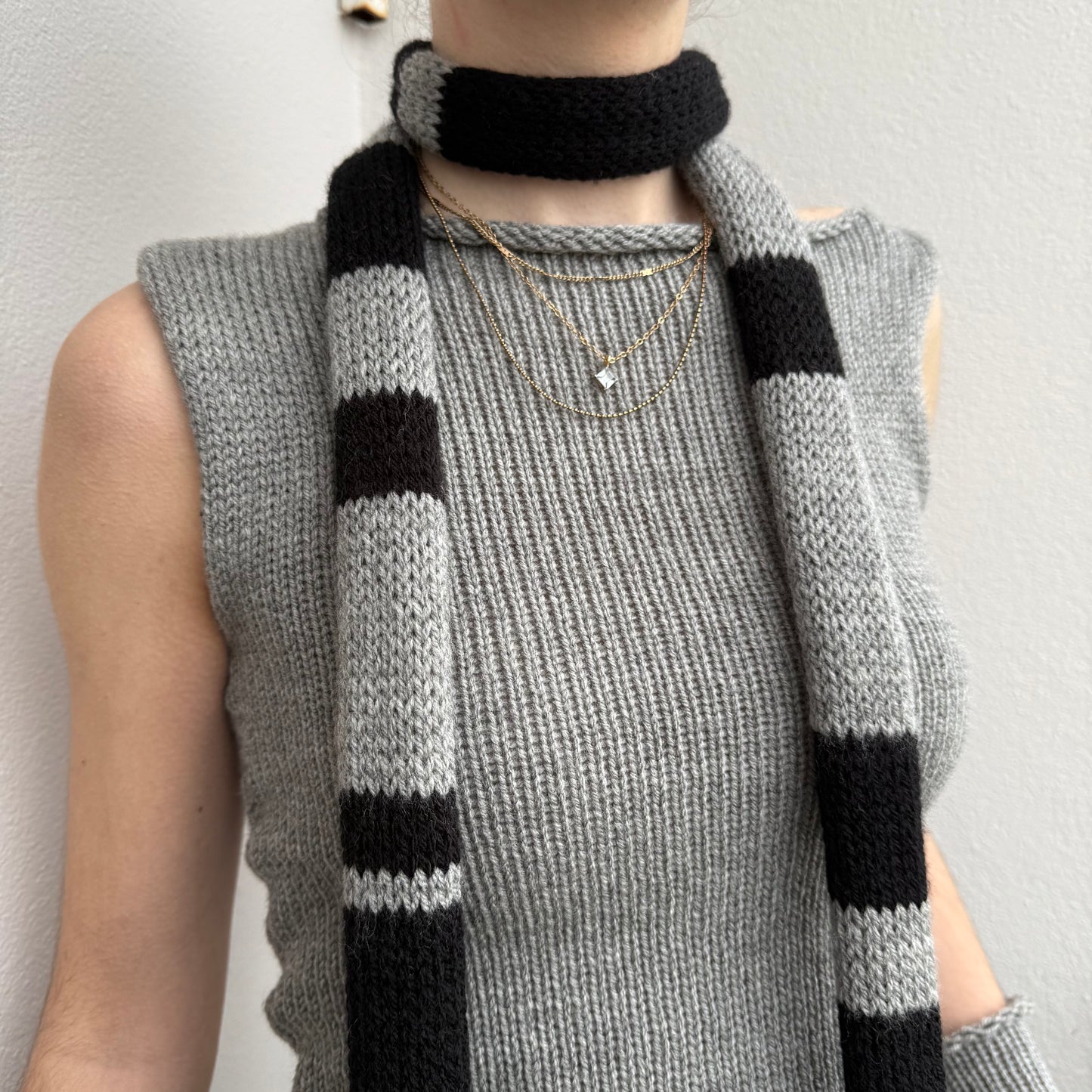 black and grey striped skinny scarf close up