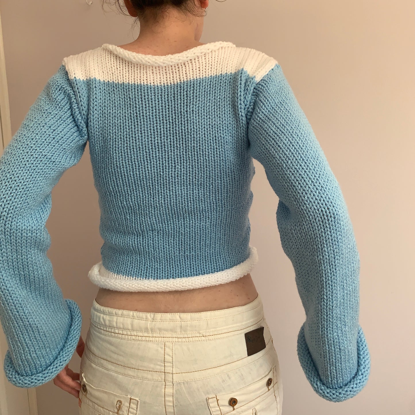 Handmade knitted colour block jumper in baby blue and white