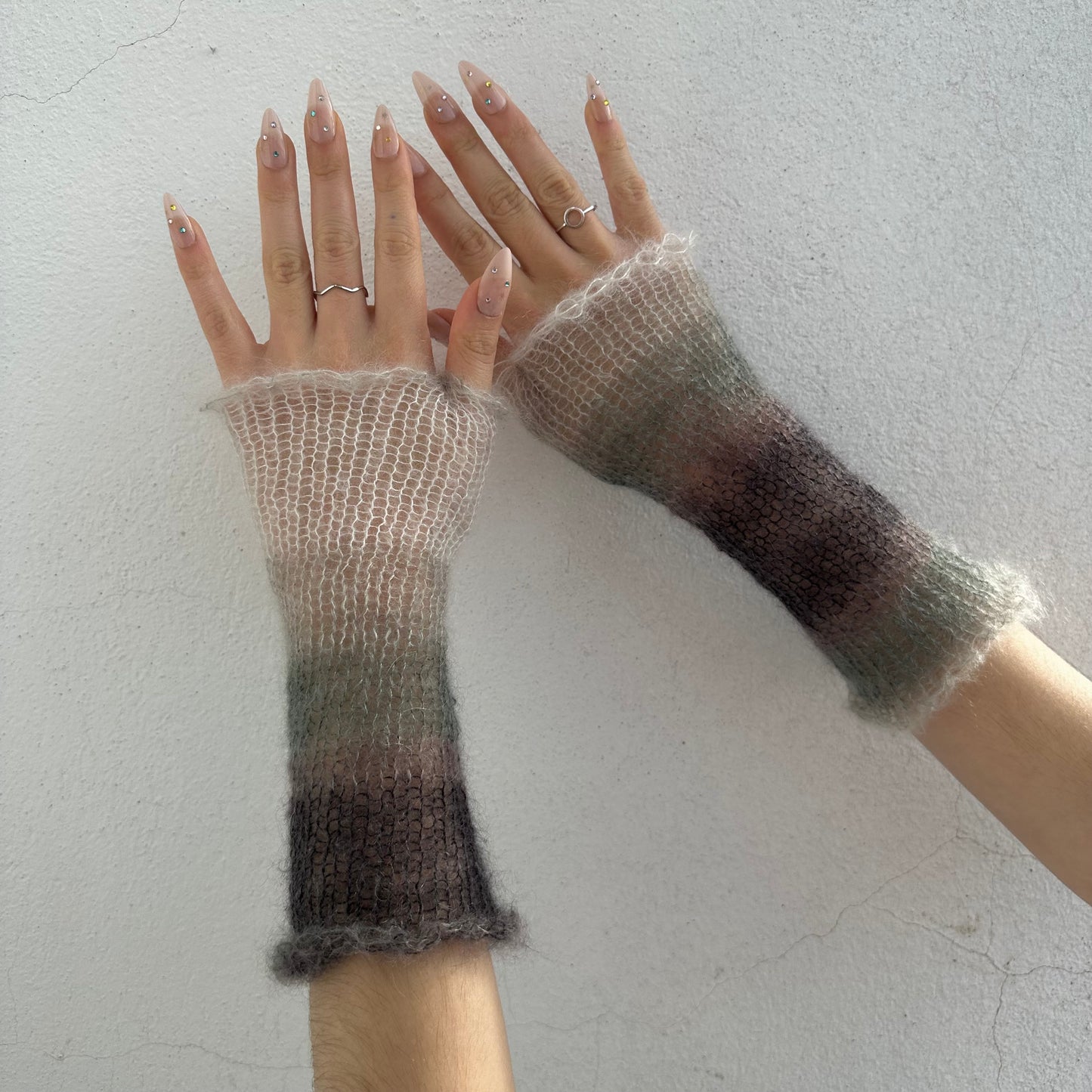 Handmade knitted mohair hand warmers in ombré black, grey and white